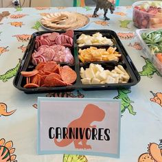 trays of food on a table with a sign that says carnivores