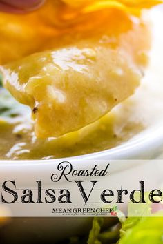 a close up of a spoon with food in it and the title reads roasted salsa verde