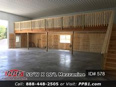 an empty garage with stairs leading up to the second floor