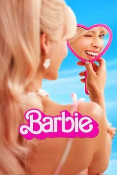 a woman looking into a mirror with the words barbie written on it in front of her face