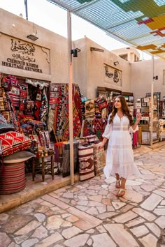 a woman standing in front of a market