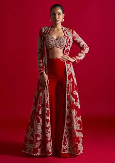 Editor's Note Featuring this red kalidaar jacket with ambi jaal embroidery paired with an embroidered bustier and gharara pants Fabric: Net georgette Color: Red Component: Jacket, bustier and garara pant Occasion: Engagement and Wedding Guest Care: Dry Clean Only About the DesignerBhumika Sharma is a luxury women’s wear label that molds ethnic materials in contemporary styles. The ensembles have a strong ethical influence with exquisitely handcrafted embroideries doused in artisanal embellishmen Bhumika Sharma, Jaal Embroidery, Inai Pengantin, Embroidered Bustier, Baju Kahwin, Trendy Outfits Indian, Diwali Outfits, Gaun Fashion, Traditional Indian Dress