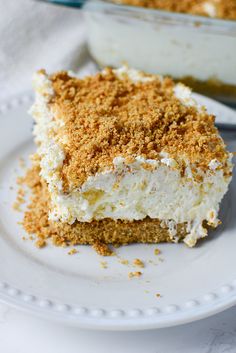 a piece of cake sitting on top of a white plate next to a pan filled with dessert