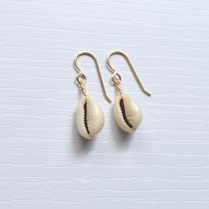 Simple & cute describe these whole cowrie shell earrings! They're the perfect accessory to wear with your favorite casual outfit when you're out & about. Please allow for variations in size and shape of shells as each is unique. Trendy Shell-shaped Jewelry Gift, Casual Shell Jewelry Gift, Handmade Cowrie Shell Earrings For Gift, Handmade Cowrie Shell Earrings As Gift, Summer Gift Shell-shaped Earrings, Cowrie Shell Dangle Jewelry For Gifts, Cowrie Shell Dangle Jewelry Gift, Gold Cowrie Shell Earrings For Gift, Gold Cowrie Shell Earrings As Gift