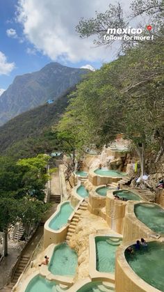 people are swimming in the water at an outdoor hot tub pool on a mountain side