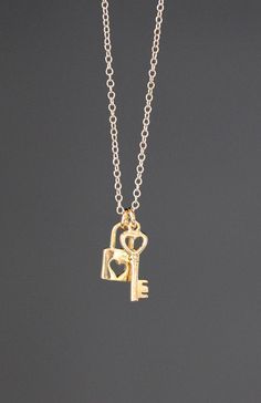 "Sweet 18k gold vermeil heart Lock and Key charms simply dangle from a 14k gold filled open link chain.  Choose from a 1mm 14k gold filled chain with a gold spring ring clasp, or a 1.5mm 14k gold filled chain with a gold lobster clasp. Each chain measures 16\" with an extension to 18\".  Please send a message if a different length chain is desired. Darling lightweight go-with-everything necklace to wear every day.  A perfect gift for someone you love! Gold Lock charm: 9x13mm Gold key charms: 6x1 Key And Lock Necklace, Key Necklace Gold, Key Locket, Lock And Key Necklace, Lock Charm Necklace, Heart Lock And Key, Gold Key Necklace, Flower Earrings Gold, Dainty Chain Necklace