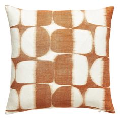 an orange and white pillow with circles on it's back, in front of a white background