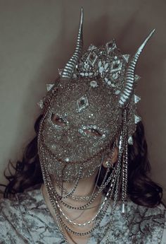 WAS £310, now £150! This fantastical mask is made from grey chenille and chiffon and is intricately beaded with silver seed beads and crystals. Chains hang down from either side and silver resin horns protude from the sides of the forehead. Small spiked elements are included here and there to give more of an edge. Not a fainthearted piece and completely unique! The 'Erembour' mask won't be recreated. Bone Headpiece, Horned Mask, Chain Headdress, Silver Headpiece, Beaded Mask, Silver Mask, Silver Head Piece, Crystal Chain, Dressed To The Nines