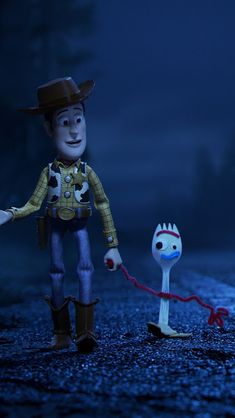 two toy figures are shown in the dark with one being pulled by a sled