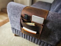 a couch with a cell phone, wallet and remote control in it's pocket