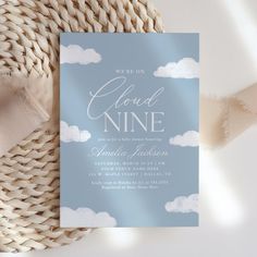 a blue and white wedding card with clouds on it