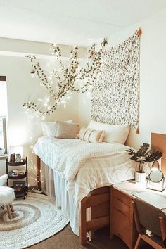 a bedroom with a bed, desk and chair next to a wall hanging on the wall