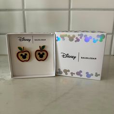 two disney earring sets in a box on a counter