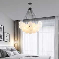 a bedroom with a bed and a chandelier hanging from the ceiling