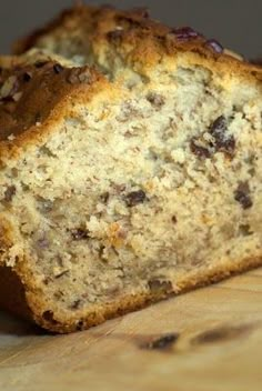 a loaf of banana bread sitting on top of a wooden cutting board