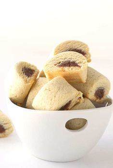 a white bowl filled with cookies sitting on top of a table