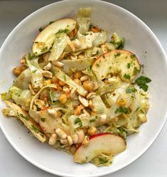 a white bowl filled with food on top of a table