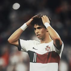 a man holding his head while standing on a soccer field