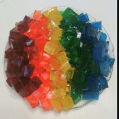 several different colored pieces of glass on a white surface