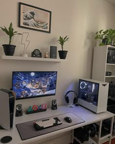 two computer monitors sitting on top of a white desk next to a keyboard and mouse