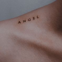 an angel tattoo on the back of a man's left arm and chest is shown