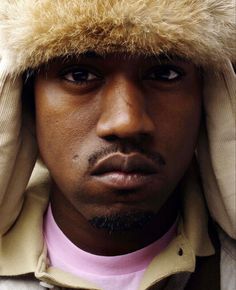 a close up of a person wearing a hat with fur on it's head