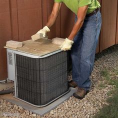 a man working on an air conditioner outside