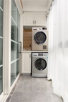 a washer and dryer sitting in a small room next to an open window