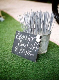 a sign that says sparkler and off on it next to some sticks in a bucket