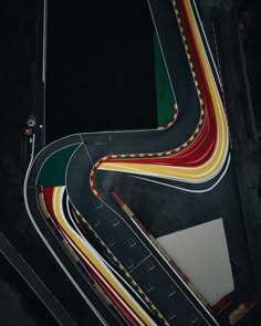 an aerial view of a winding road in the dark