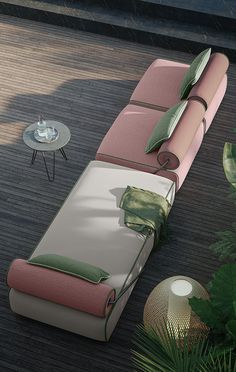 a couch that is sitting on the ground next to a table and potted plant