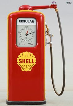 a red and yellow shell gas pump sitting on top of a white floor next to a hose