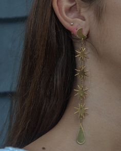 SWINGING STARS WHAT IT IS: Extra-long drop earrings consisting of bright gold dangling stars WHY IT’S SPECIAL: These magical earrings are made for daydreamers and moon chasers At 5" long, they're a sleek shiny statement, that is surprisingly easy to pull off GOOD TO KNOW: Hand-hammered brassSterling silver postsNickel- and lead-freeLength: 5” WHY WE LOVE WE DREAM IN COLOUR: Create a moment—every moment—you’re wearing We Dream in Colour. We love how they use all the hues of the rainbow and we are Celestial Star Jewelry For Festival, Celestial Star-shaped Festival Jewelry, Celestial Festival Star Jewelry, Gold Star Charm Jewelry For Festival, Gold Festival Jewelry With Star Charm, Magical Earrings, Star Earrings Dangle, Extra Long Earrings, Minimalist Studs