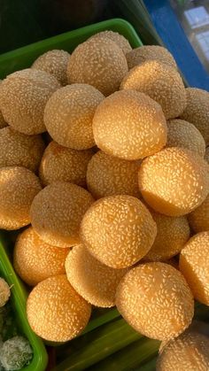 there are many different types of food in the trays on this market stand, including cantaloupe and broccoli