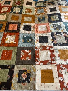 an old quilt is laying on the floor