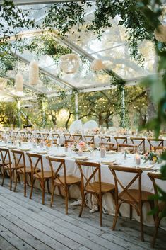 an outdoor dining area with tables and chairs set up for a formal dinner or party