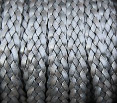 a close up view of a silver colored braided rope that looks like it has been woven