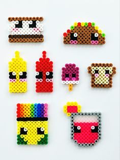 six pieces of perler bead art on a white surface, each with different designs and colors