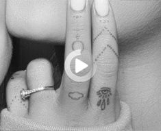 two people with tattoos on their fingers, one is holding the other's hand