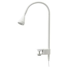 an image of a white lamp on a wall mounted light fixture that is plugged in