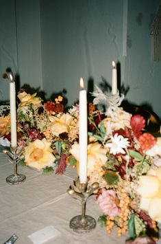 a table with candles and flowers on it