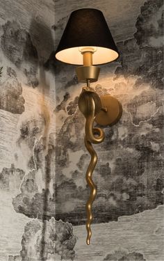 a lamp that is on the side of a wall in a room with clouds painted on it