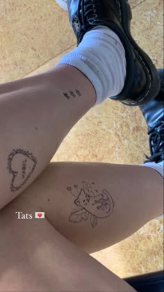 two people with matching tattoos on their legs