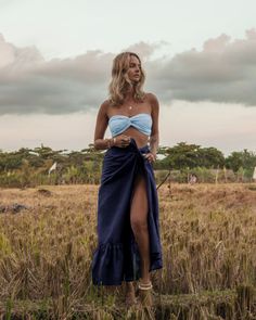 The embodiment of summer, this lightweight slik wrap skirt is printed with the prettiest floral pattern in a rainbow of happy colors. Tie it over a bodysuit, mix it or match it with our too cute Bia bandeau tops and the matching easy Brizo top. Style it wrapped or ruched. There’s no going wrong here. Color: Navy 100% Thai Silk Long, flowing silhouette Graceful understated ruffle Long soft tie for multiple wrap options Ruffle length 12.5” Overall length 43” Dry clean or gently cold water hand was Breezy Ruffled Maxi Skirt For Summer, Summer Gathered Maxi Skirt For Day Out, Summer Vacation Maxi Skirt With Gathered Details, Summer Vacation Gathered Maxi Skirt, Breezy Beach Maxi Skirt With Ruffles, Breezy Summer Maxi Skirt, Breezy Ruffled Maxi Skirt For Beach, Breezy Ruffled Maxi Skirt For Vacation, Summer Beachwear Tiered Skirt