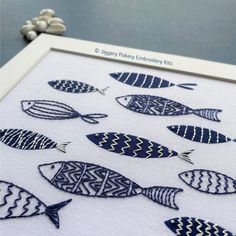 a cross stitch fish pattern in blue and white