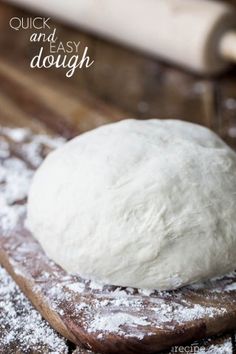 a ball of dough sitting on top of a wooden cutting board