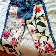 two pairs of jean shorts with flowers on them