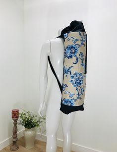 a mannequin wearing a blue and white floral print dress with a black hoodie