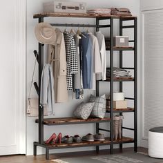 an open closet with clothes and shoes on shelves in front of a window, next to a suitcase