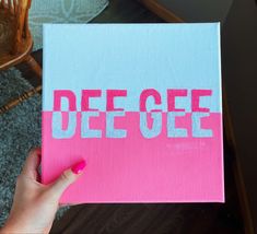 a person holding up a piece of paper with the word decre written on it